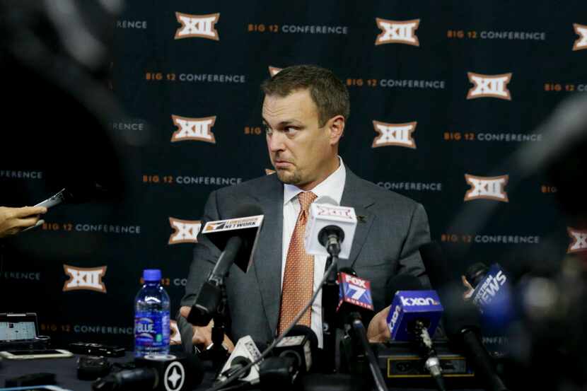 Texas head football coach Tom Herman listens to a reporter's question during the Big 12 NCAA...