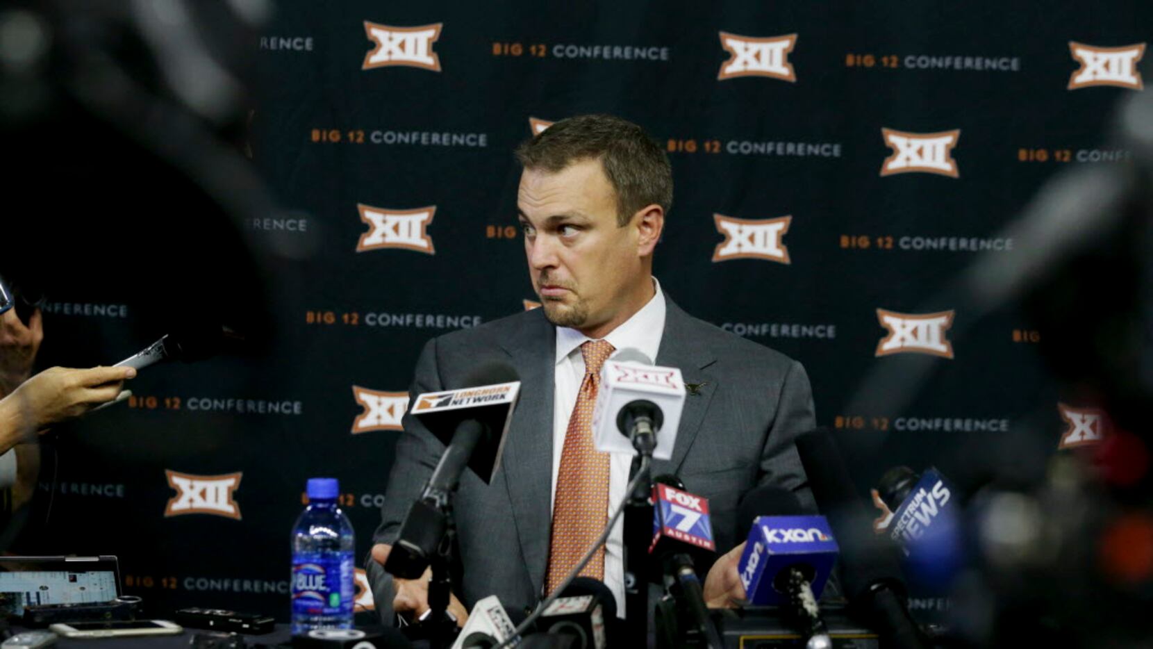 Texas head football coach Tom Herman listens to a reporter's question during the Big 12 NCAA...