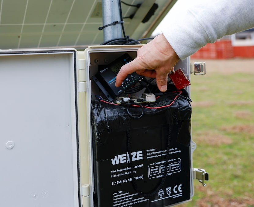 Rodrigues shows the inside of a piece of equipment that his team created to collect data...