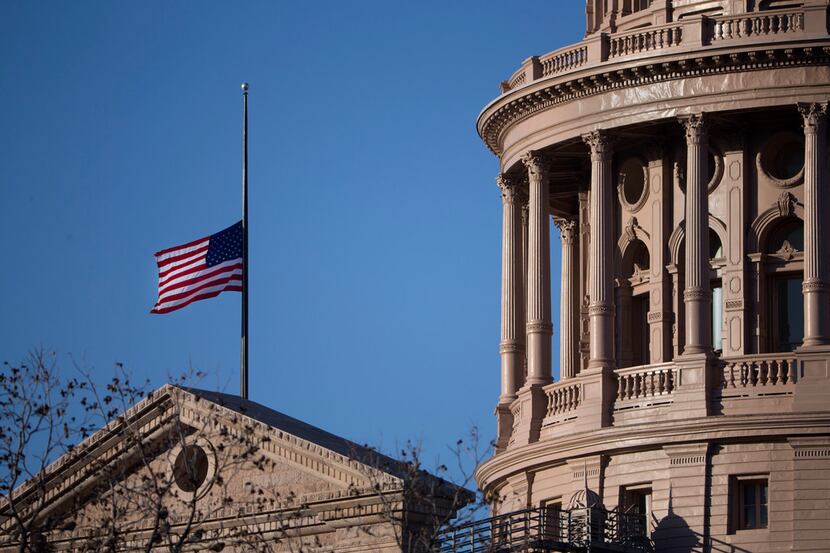 The U.S. flag flies at half staff over the Texas Capitol in honor of former President George...
