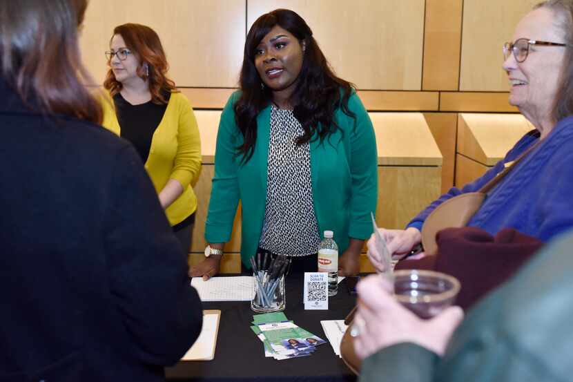 Candidate Paige Dixon (center) meets with voters after a Texas House District 65 candidate...