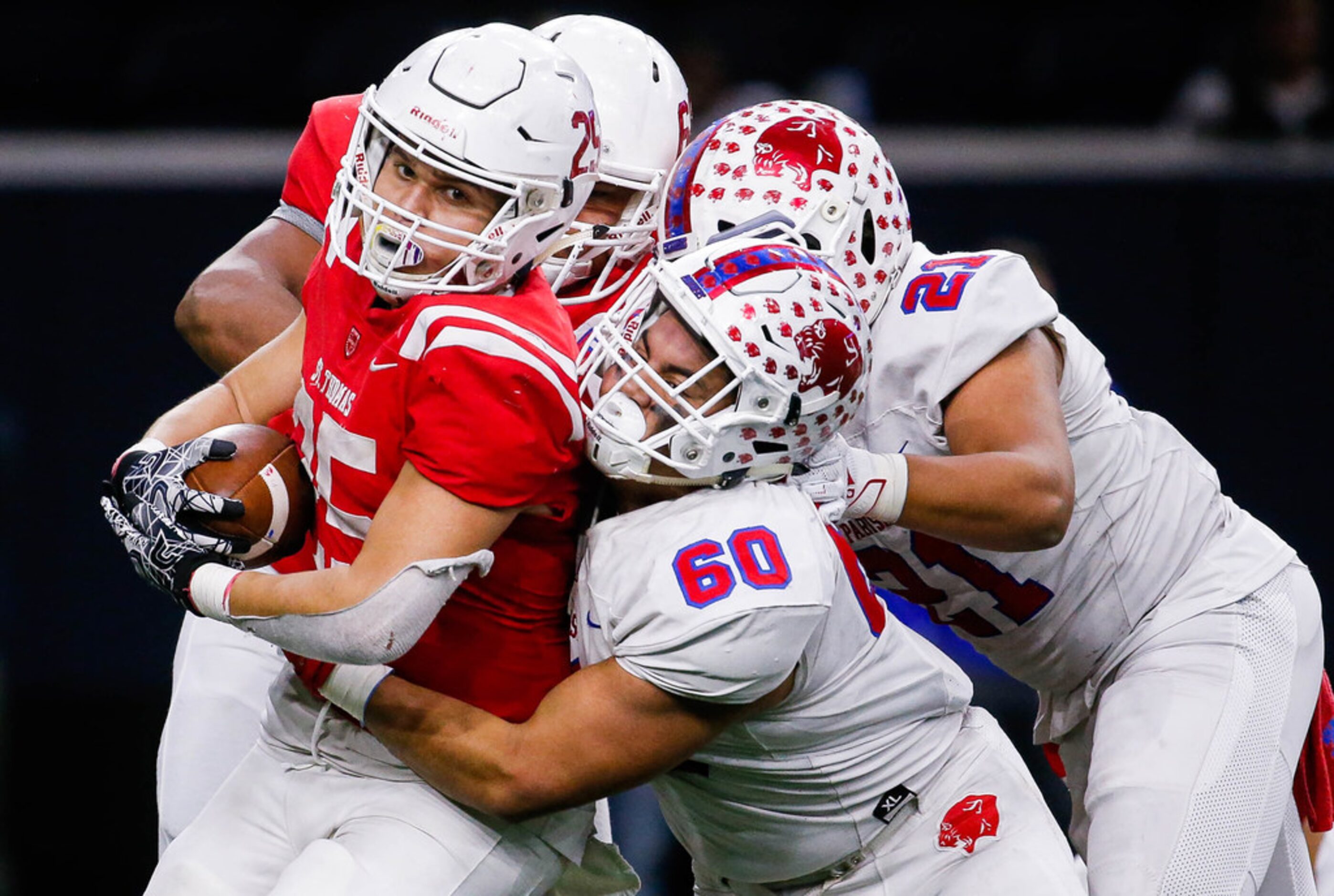 Parish EpiscopalÃs Josue Munoz (60) and Keegon Addison (21) tackle Houston St. ThomasÃ...