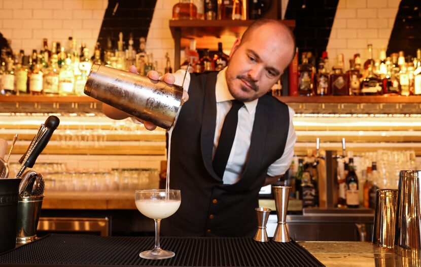 Bar manager Drew Garison pours a daiquiri at Brass Ram. 