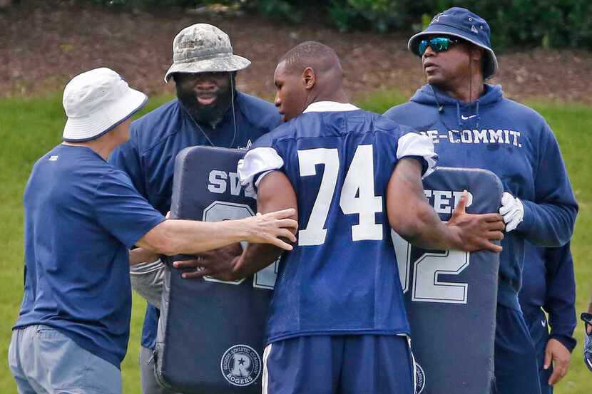 Dallas Cowboys defensive end Dorance Armstrong (74) gets some help from the coaching staff...