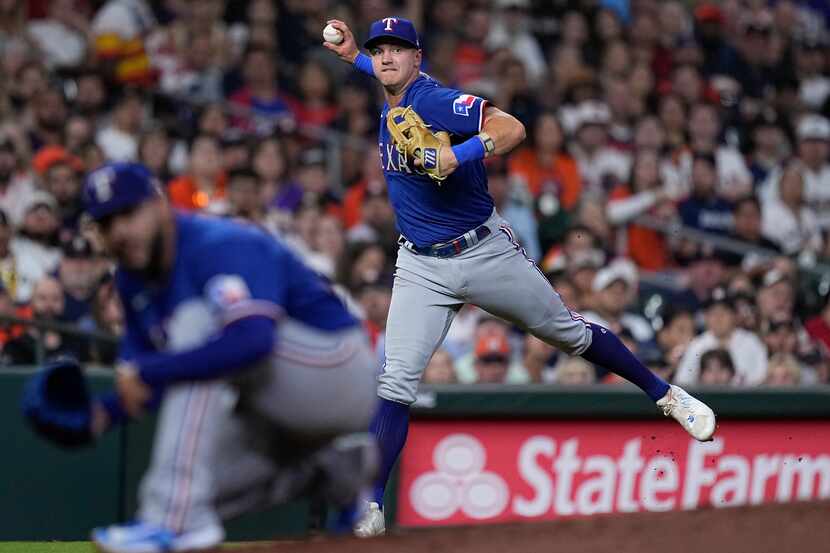 Texas Rangers third baseman Josh Jung throws out Houston Astros' Alex Bregman during the...