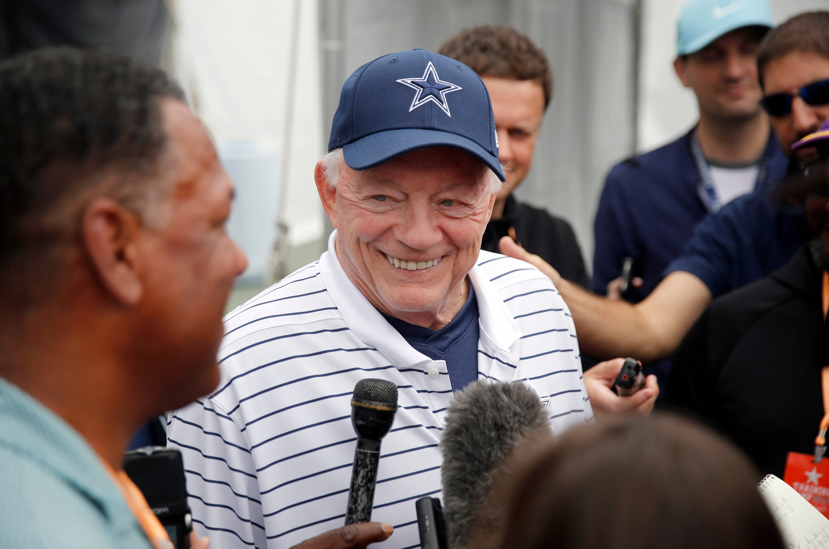 Dallas Cowboys owner Jerry Jones visits with reporters on the side following his kickoff...