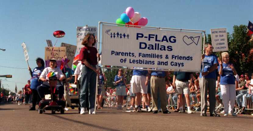 Members and supporters of Parents, Families & Friends of Lesbians and Gays (PFLAG) show...