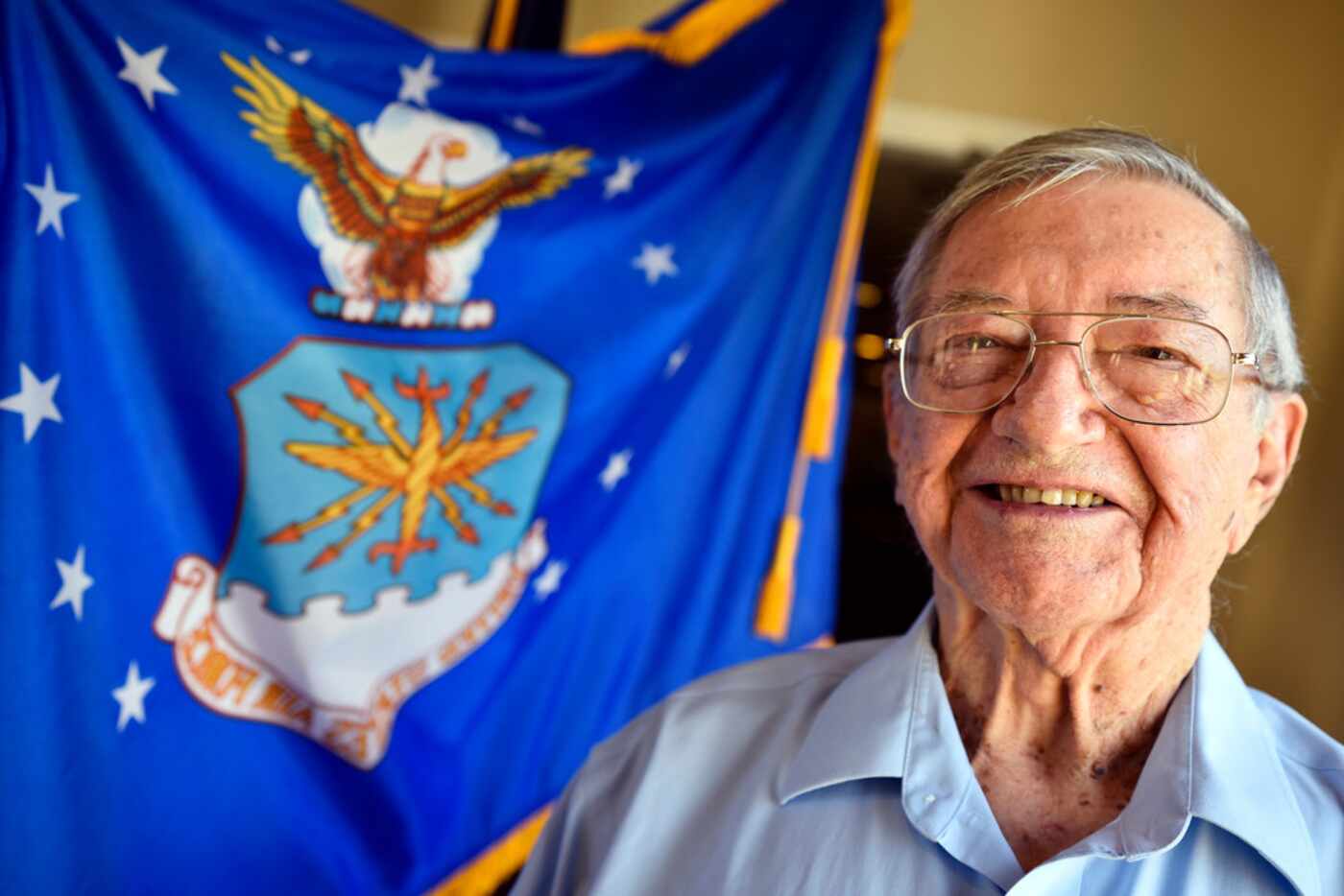Air Force veteran Jorge Masek, 87, photographed with the Air Force flag at the Treemont...
