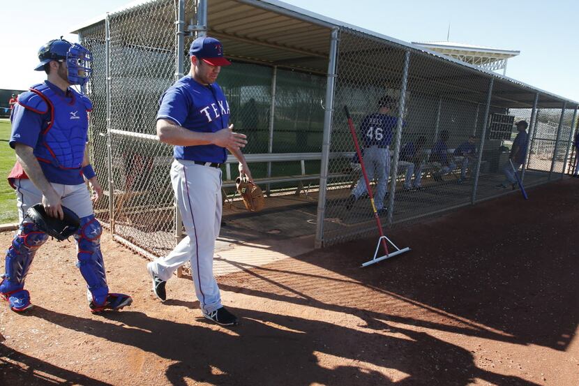 Texas pitcher Colby Lewis heads to the mound for his first work of the spring during Texas...