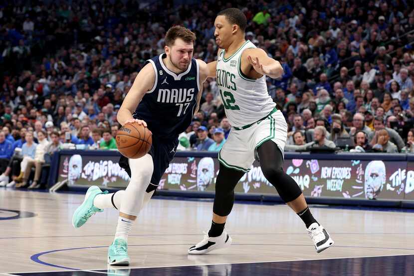 Luka Doncic of the Dallas Mavericks drives to the basket against Grant Williams of the...