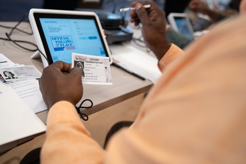 Mitchell Curtilearns how to operate an e-pollbook at the Dallas county elections...