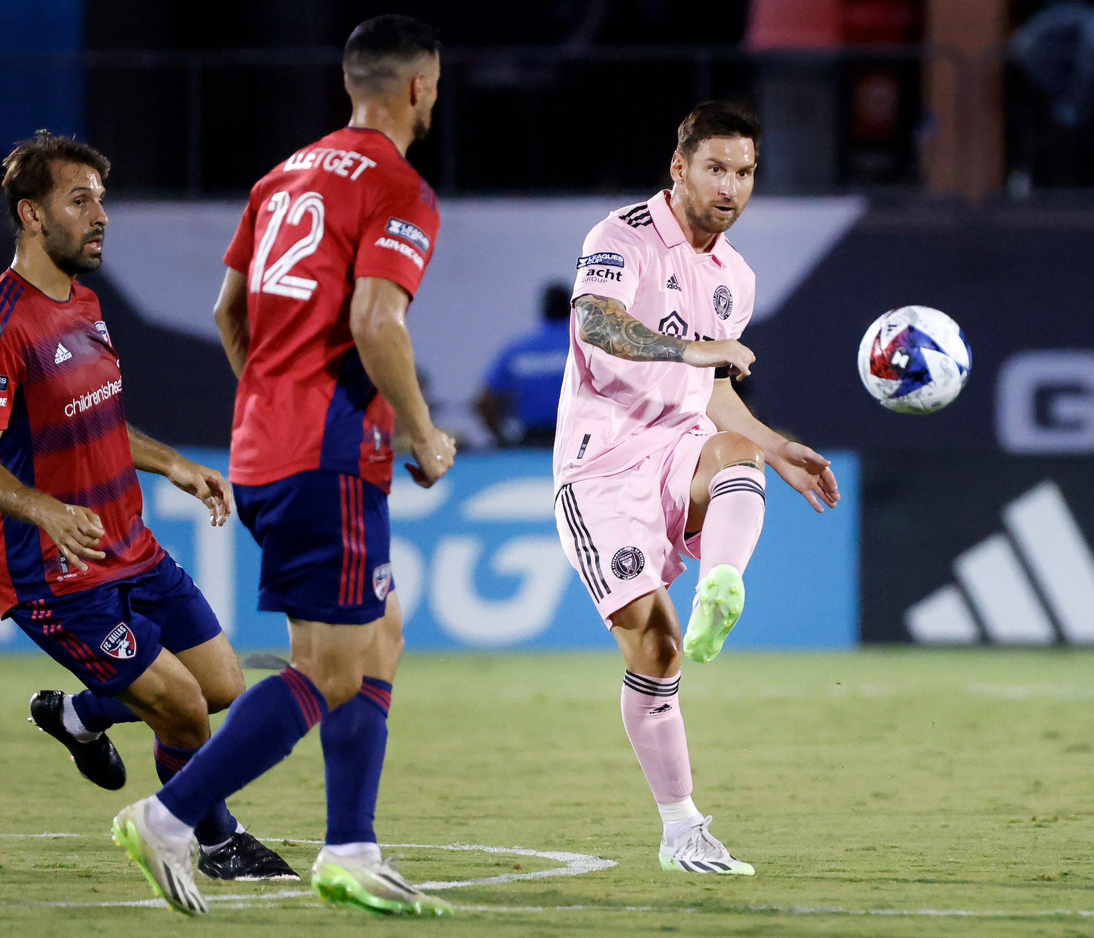 Inter Miami forward Lionel Messi (10) passes the ball past FC Dallas midfielder Sebastian...