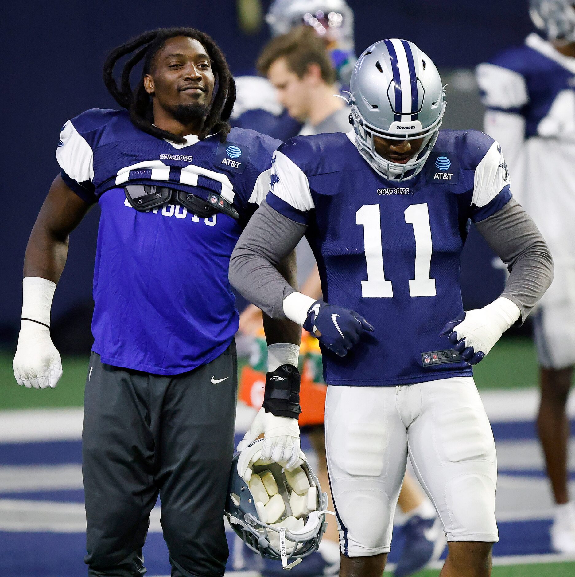 Dallas Cowboys defensive end DeMarcus Lawrence (90) and rookie inebacker Micah Parsons (11)...