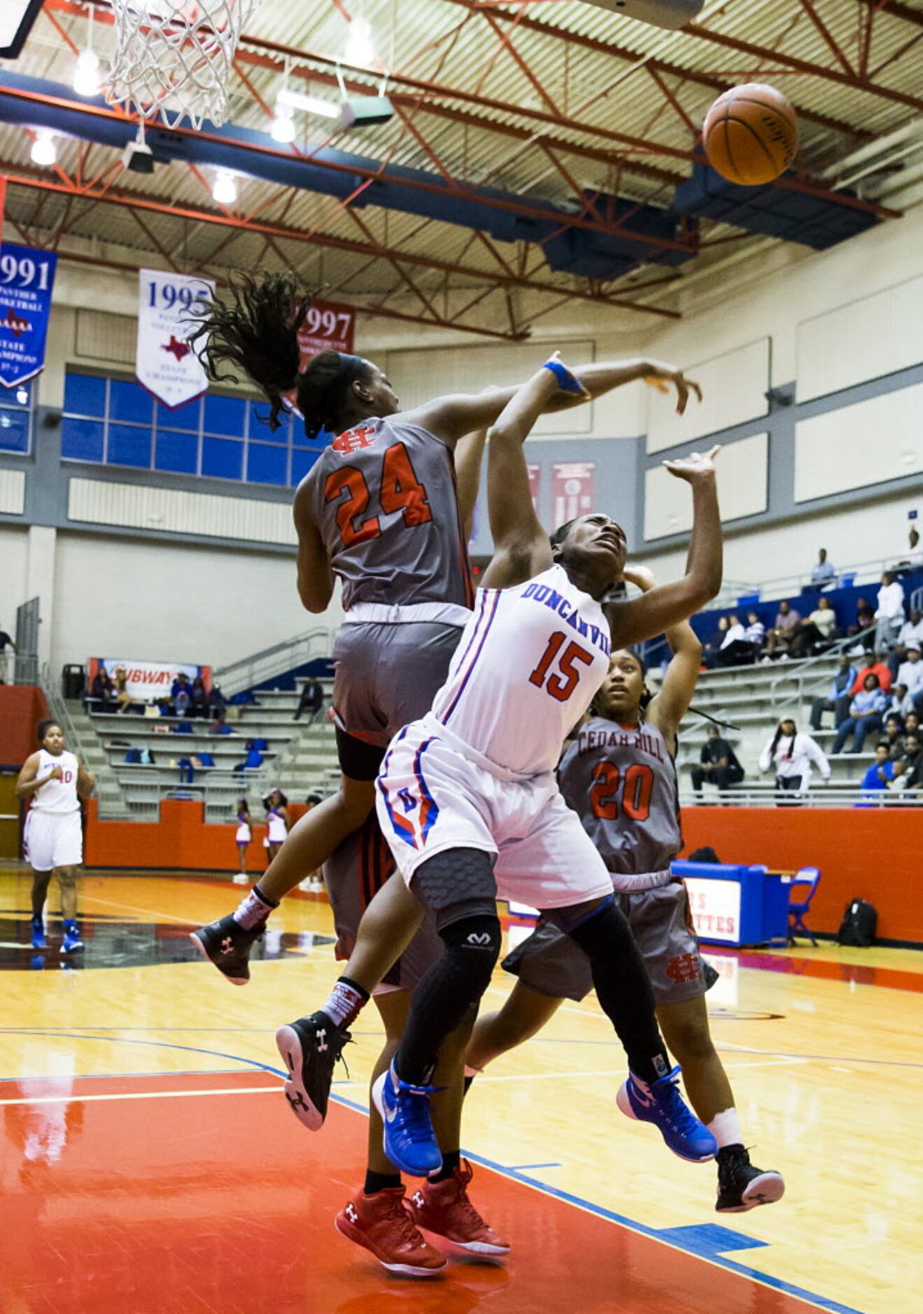 Cedar Hill forward Joyner Holmes (24) swats a shot away by Duncanville guard Tae Davis (15)...