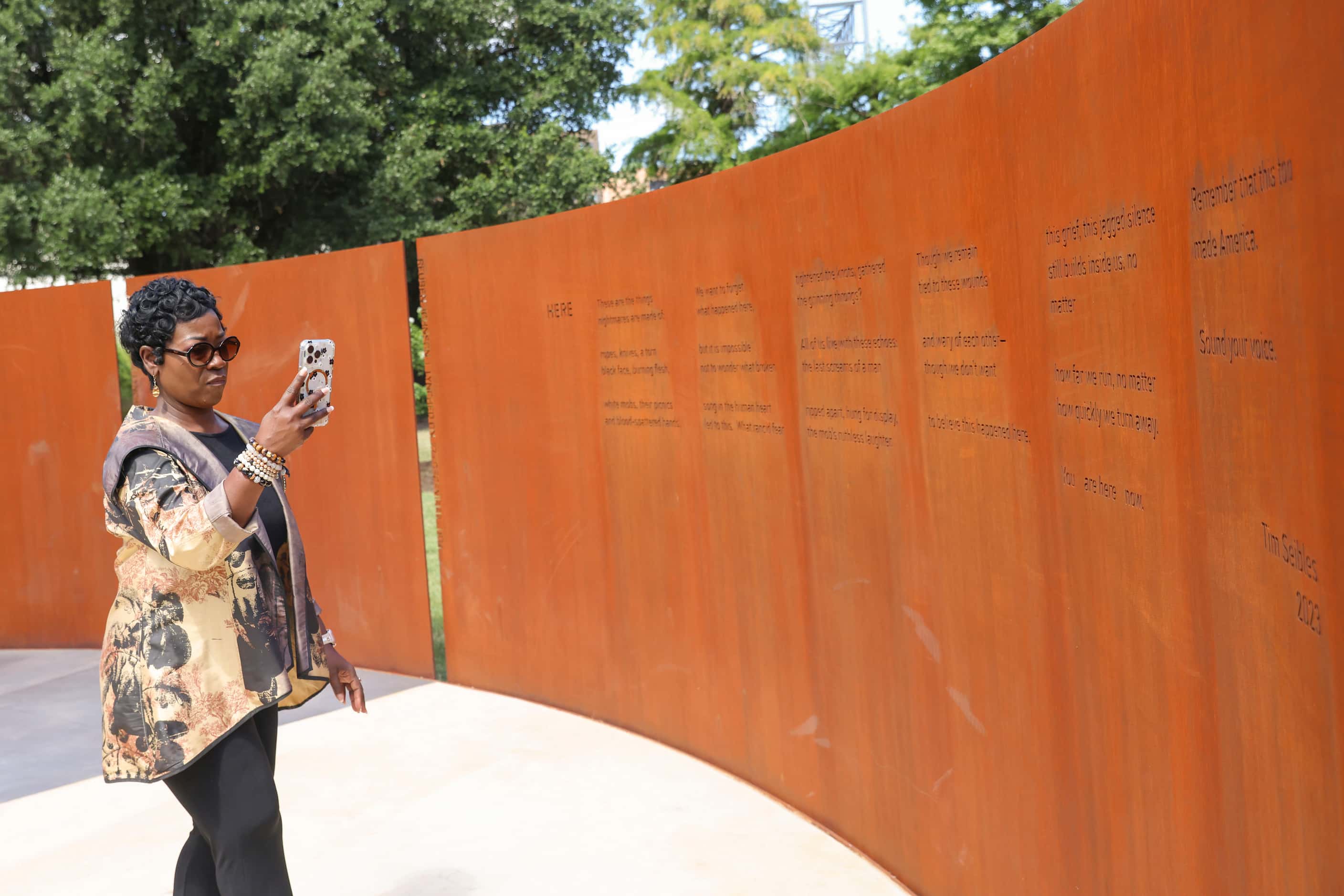 Dallas Interim City Manager Kimberly Tolbert walks around the sculpture entitled Shadow...