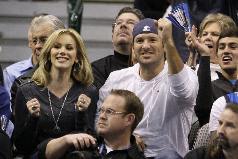 Dallas Cowboys quarterback Tony Romo, right, reacts to a play as he and his then-fiancee,...