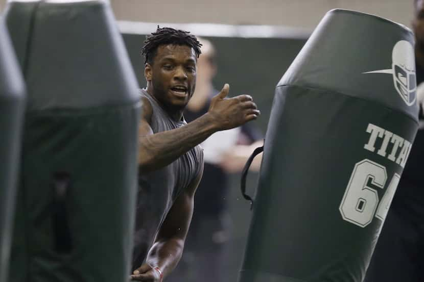 Defensive end Shilique Calhoun runs through a drill for NFL scouts at a Pro Day college...