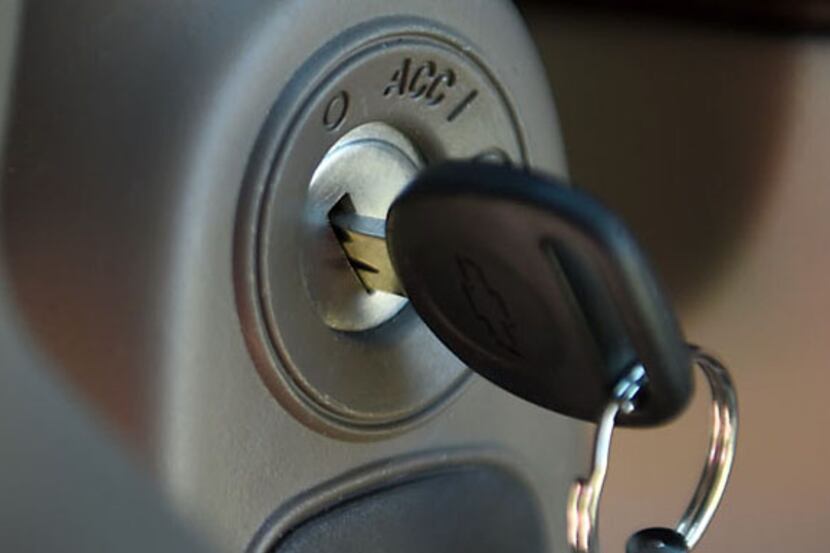 A key hangs in the ignition switch of a 2005 Chevrolet Cobalt. General Motors said in its...