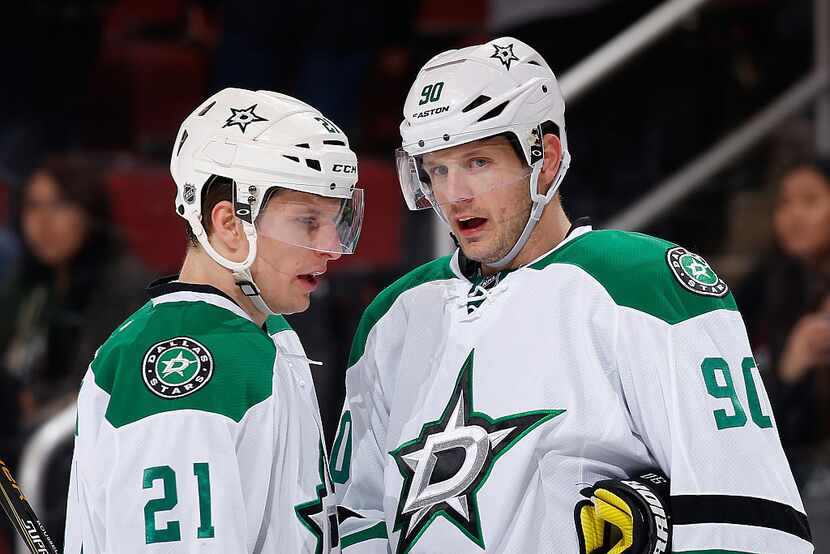 GLENDALE, AZ - FEBRUARY 18:  Antoine Roussel #21 and Jason Spezza #90 of the Dallas Stars...