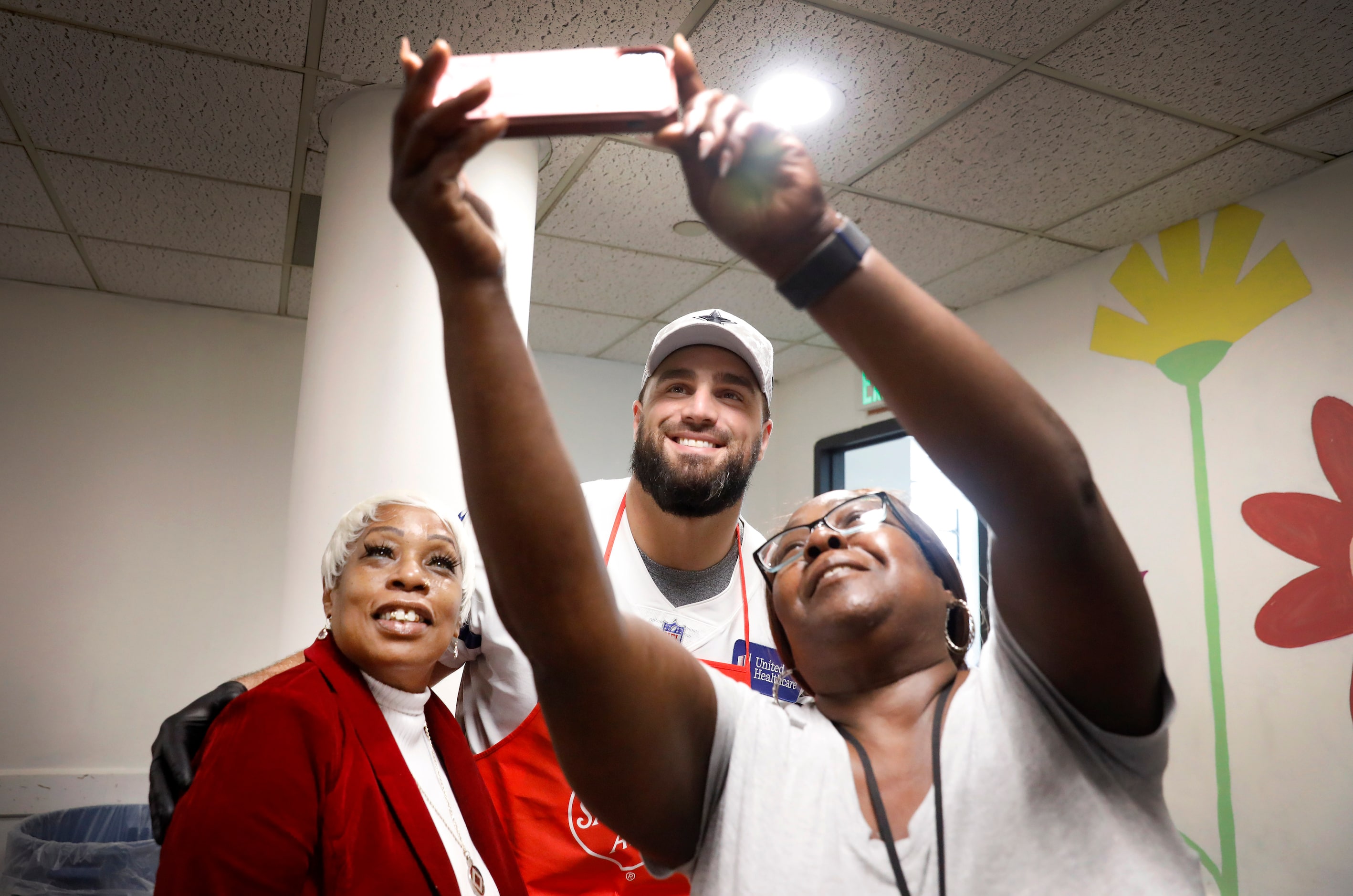 Dallas Cowboys offensive tackle Dakoda Shepley (65) takes a selfie with case aides Kimberly...