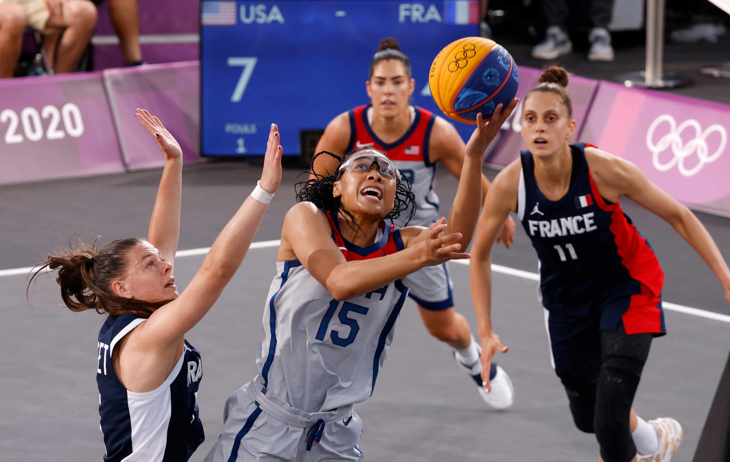 USA’s Allisha Gray (15) attempts a shot in front of France’s Marie-Eve Paget (5) during a...