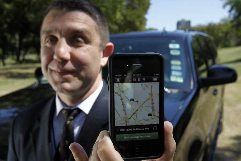  A Dallas driver for San Francisco-based Uber displays the ride-hailing app on a smartphone.