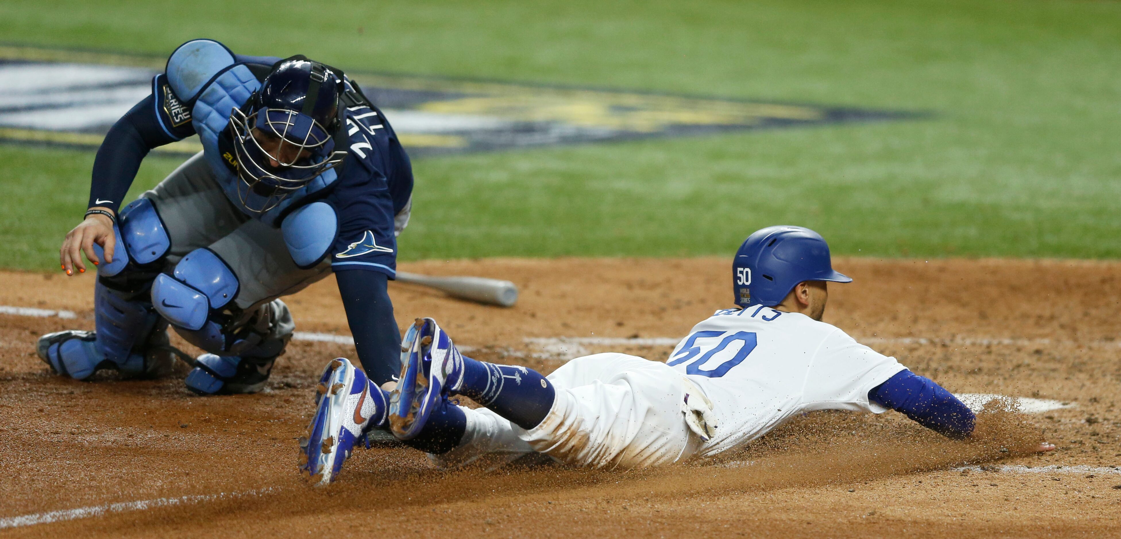 Los Angeles Dodgers right fielder Mookie Betts (50) safely slides home for a run as Tampa...