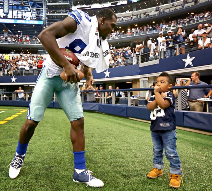 Dallas Cowboys wide receiver Dez Bryant (left) plays with his 3-year-old son, Dez Bryant,...