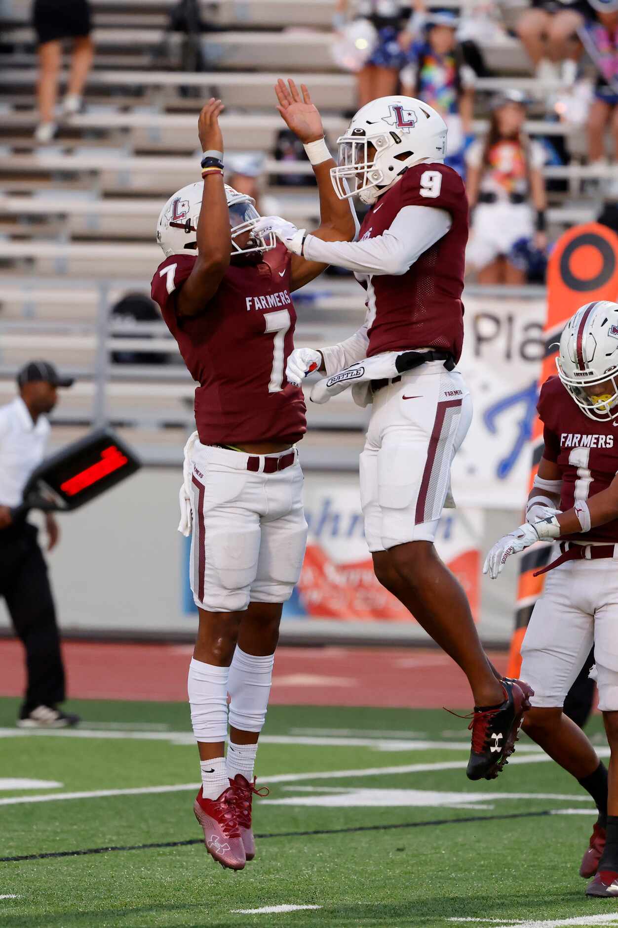 Lewisville quarterback Ethan Terrell (7) congratulates  Armani Winfield (9) after they...