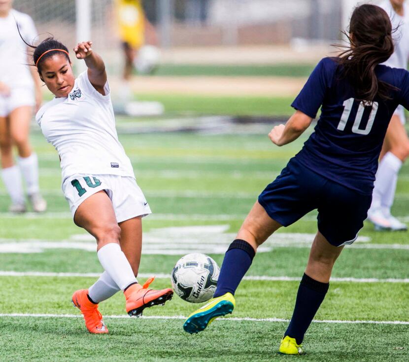 Kennedale's Alondra Olmos (10) and Stephenville's Tori Fairchild (10) reach to kick the ball...