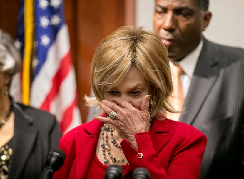 State Rep. Helen Giddings, D-DeSoto, wipes a tear while speaking at a news conference at the...