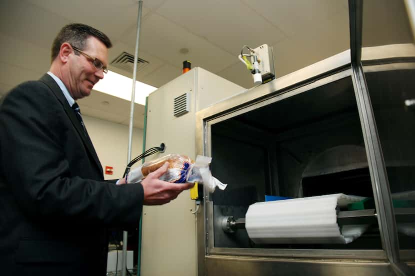 In this Dec. 6, 2012, photo, Don Stull, chief executive officer of Microzap, Inc., places a...