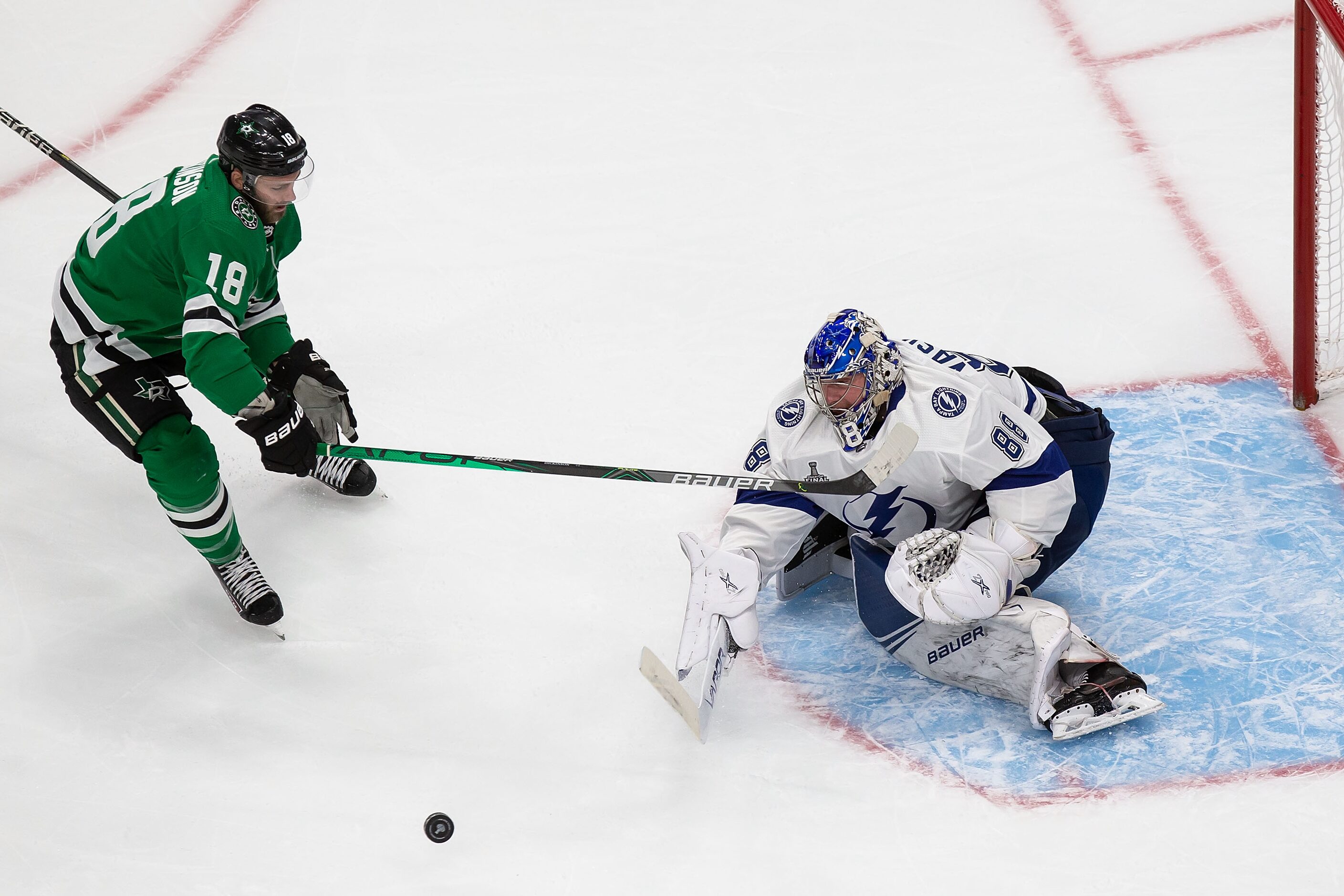 Jason Dickinson (18) of the Dallas Stars takes a shot against goaltender Andrei Vasilevskiy...