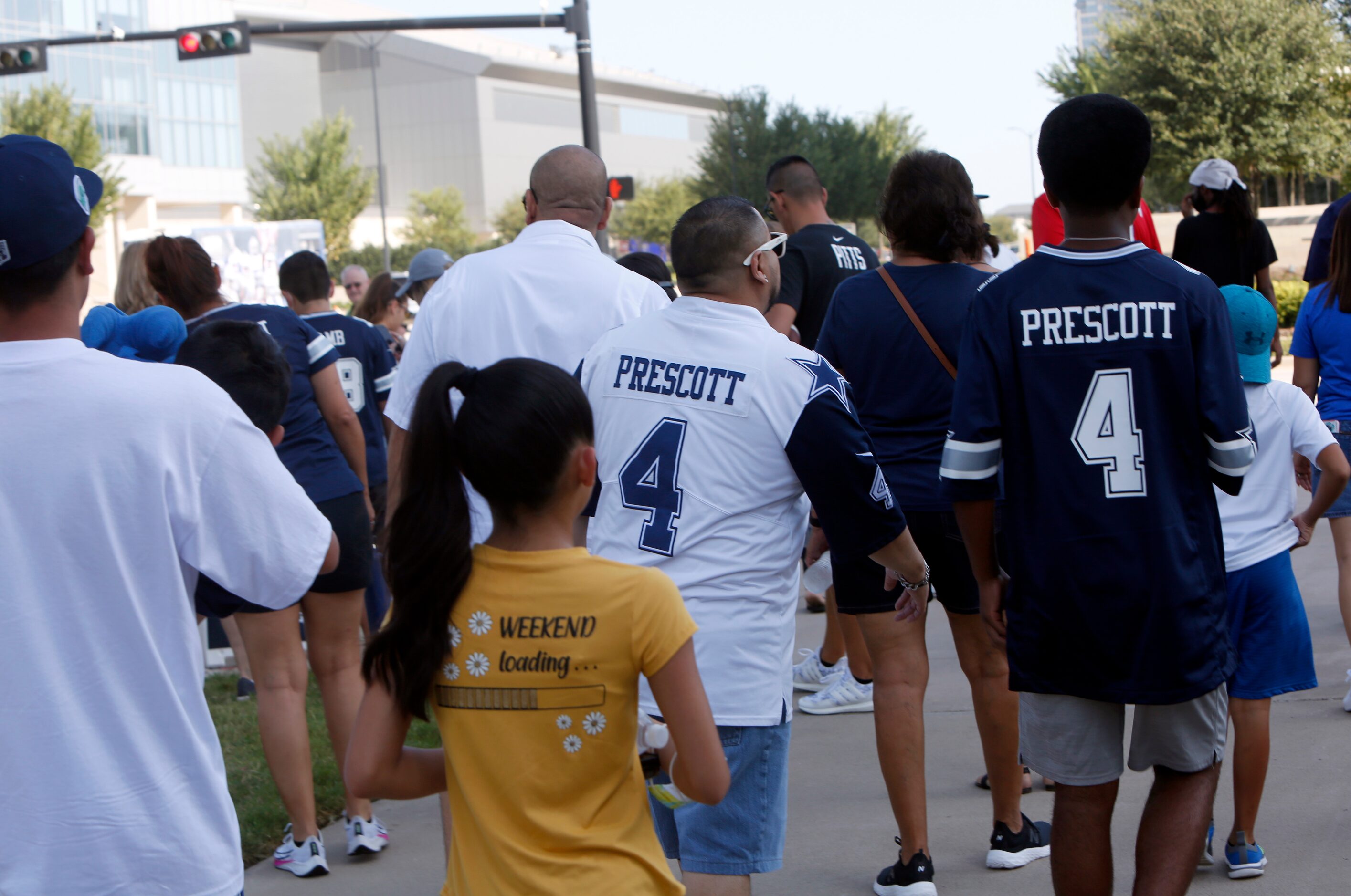 Dallas Cowboys fans make their way to attend a team practice session. The Cowboys conducted...