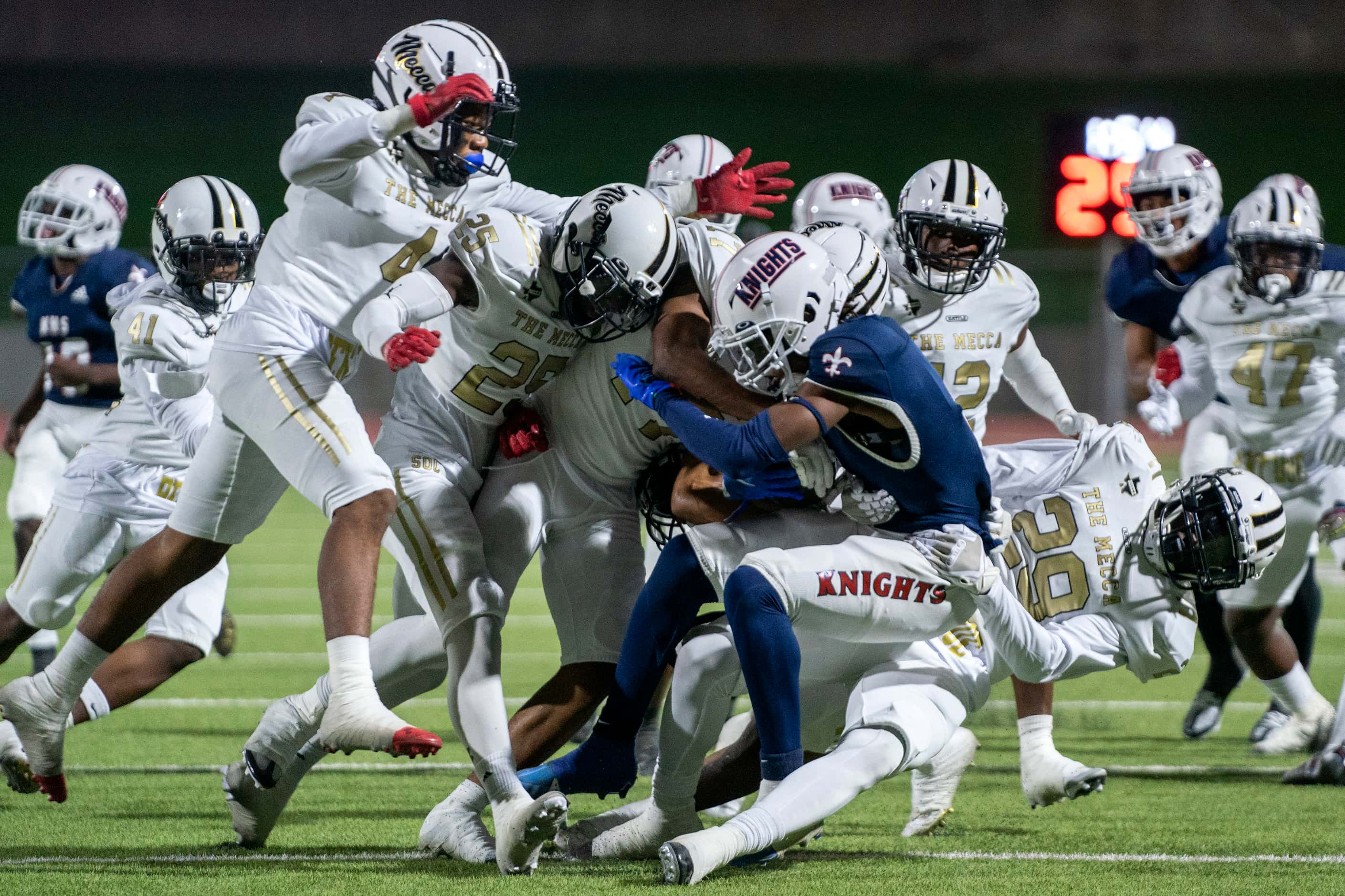 Kimball junior kick returner Jordan Martin (6) is brought down by a crowd of South Oak Cliff...