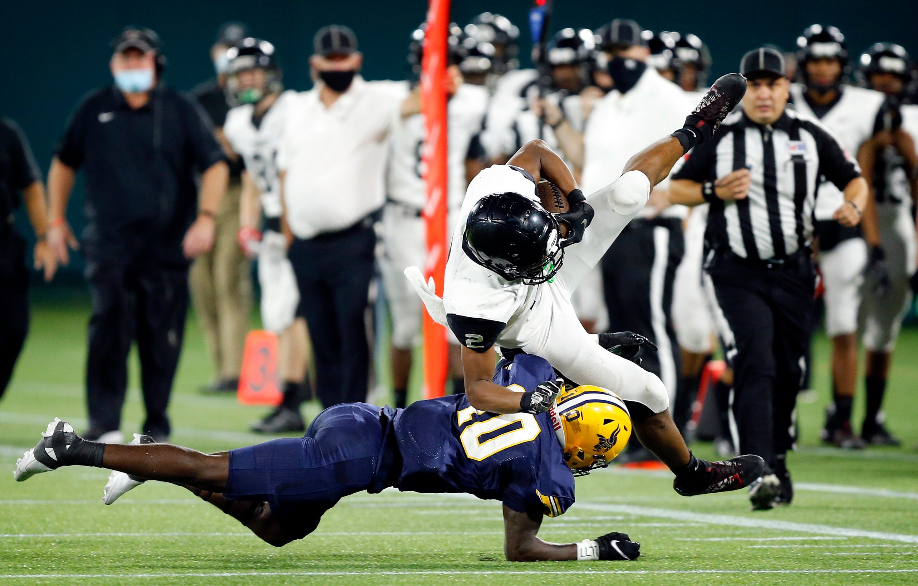 Arlington Lamar defensive back Harold West (10) takes the foot out from under Euless Trinity...