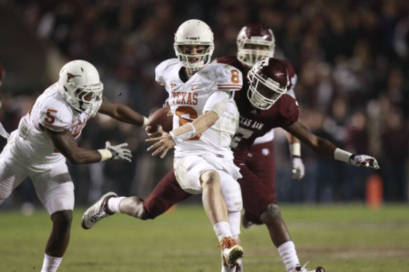 Texas Longhorns quarterback Case McCoy (6) runs for a first down that led to their...