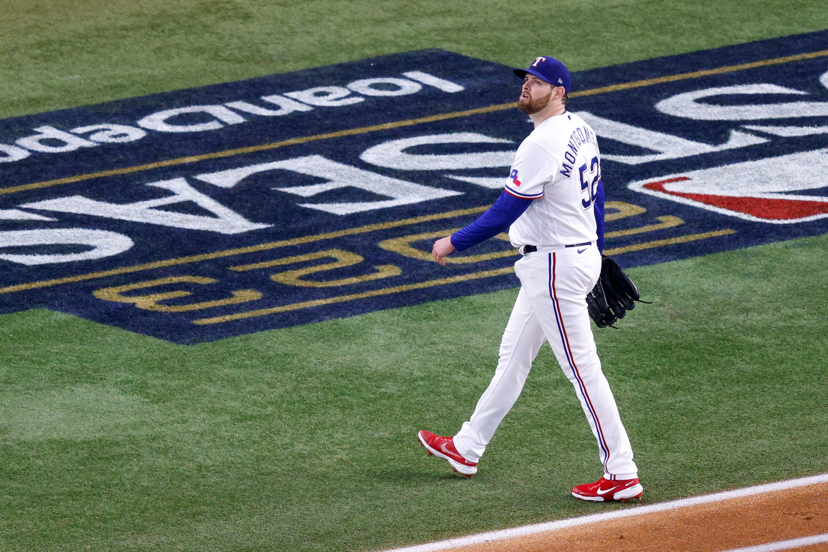 Texas Rangers starting pitcher Jordan Montgomery walks to the dugout after giving up a home...