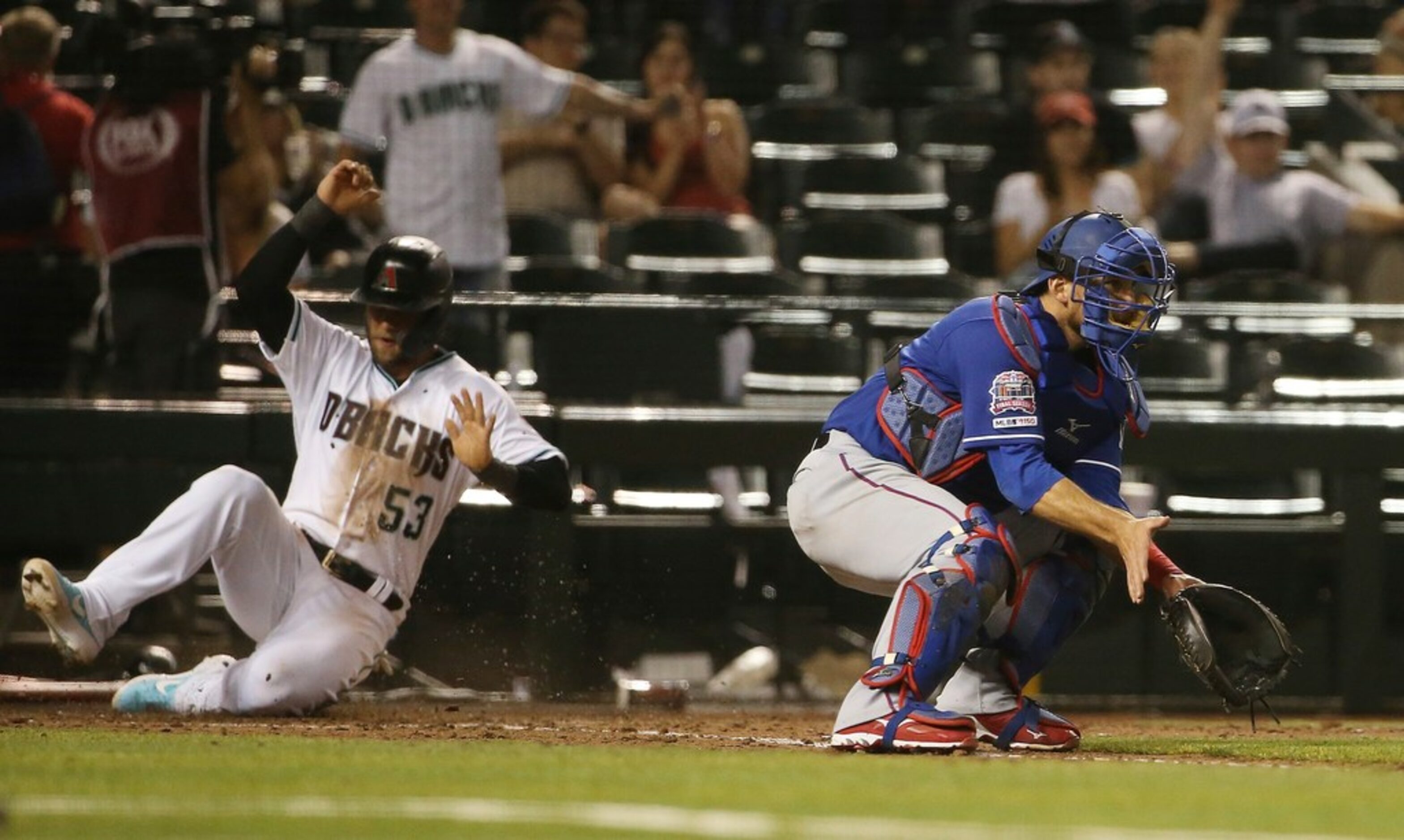 Arizona Diamondbacks' Christian Walker (53) scores a run as Texas Rangers catcher Jeff...