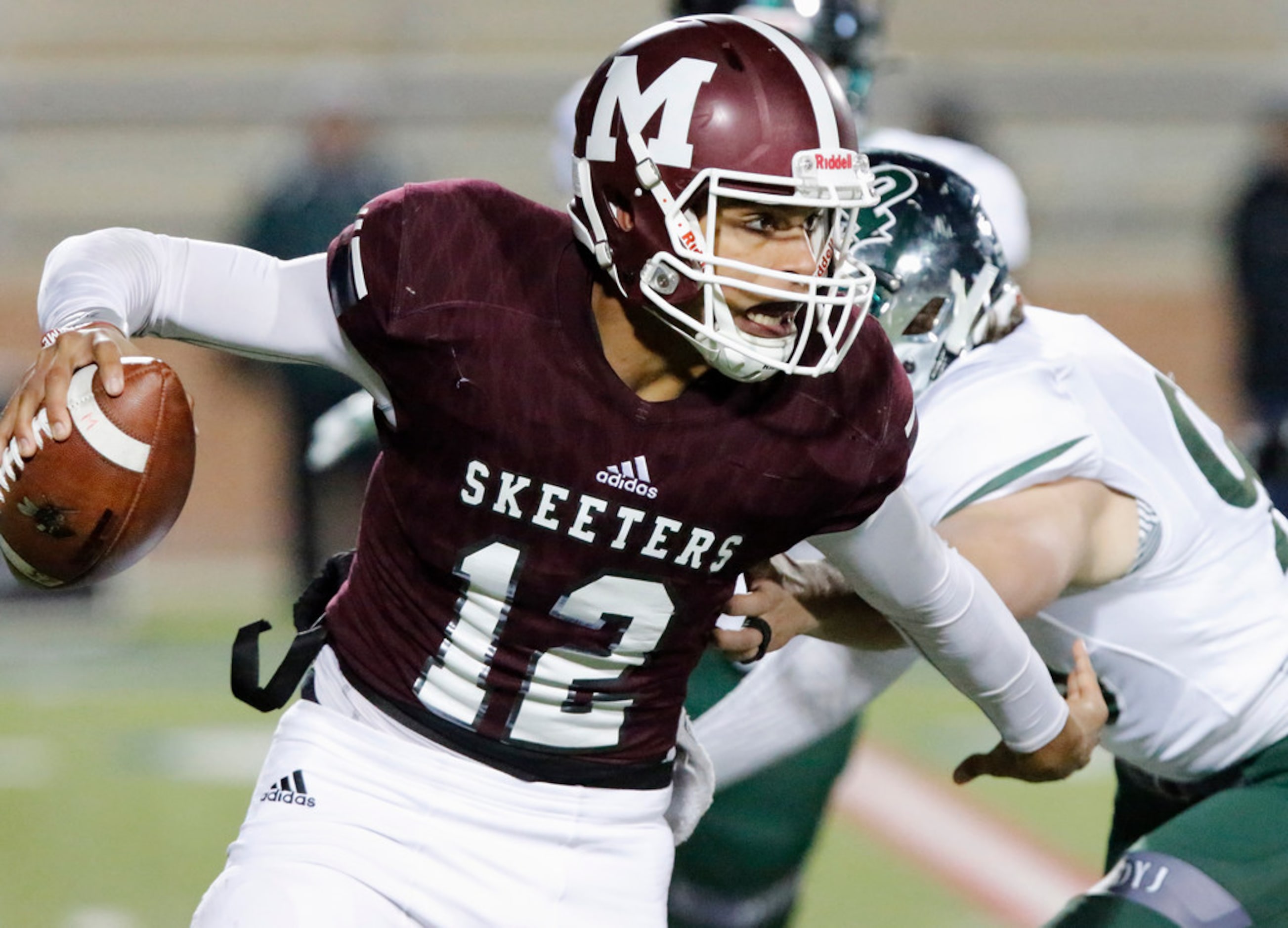 Mesquite High School quarterback Dylan Hillard-McGill (12) escapes from Prosper High School...