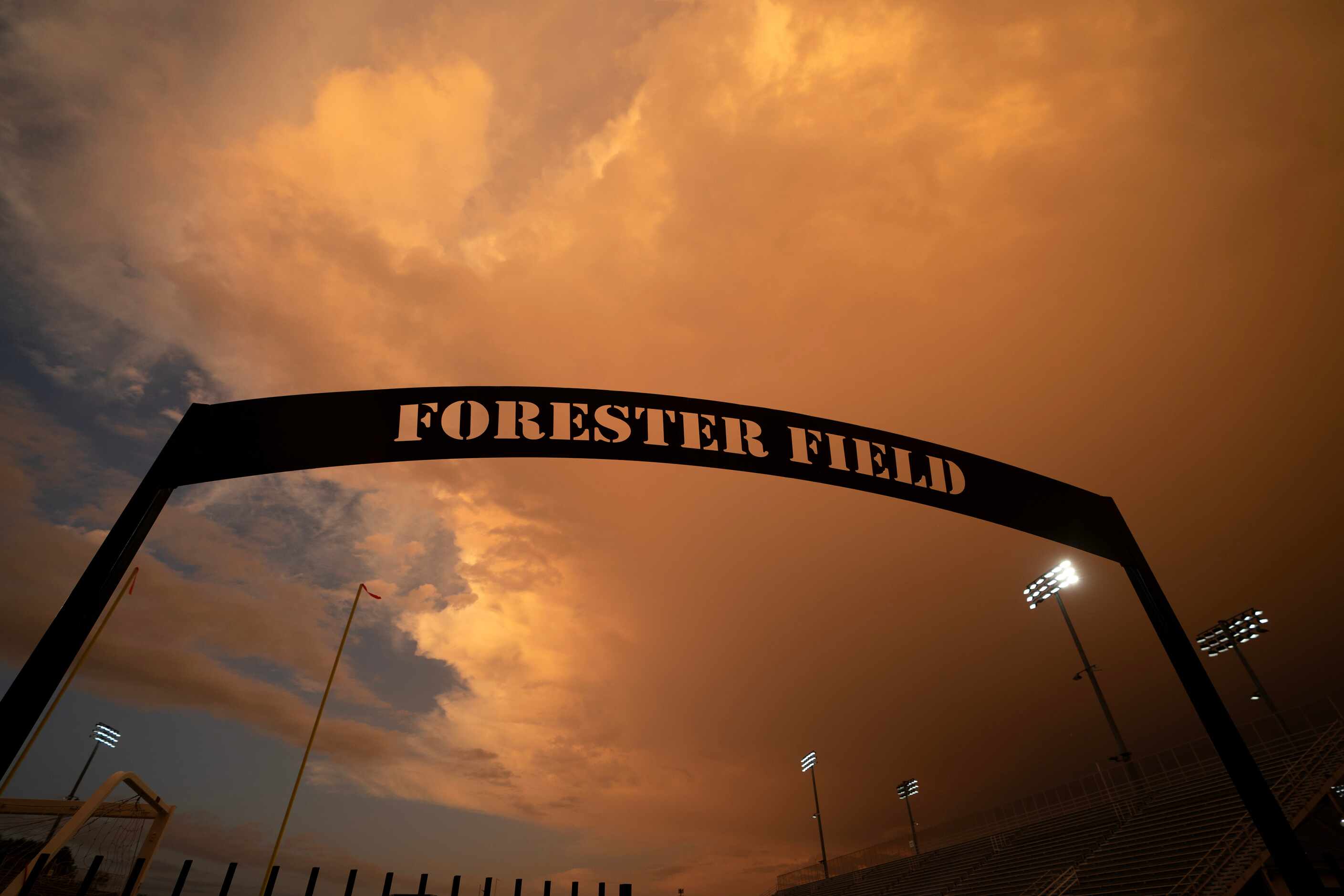 storm clouds hang low as the sun sets over Forester Field during a lightning delay before a...
