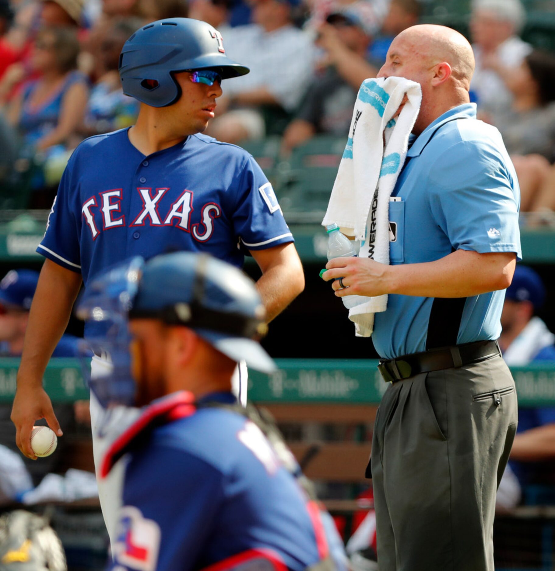 The ballboy and Texas Rangers' Jeff Mathis, back left, stands by as umpire Ryan Blakney,...