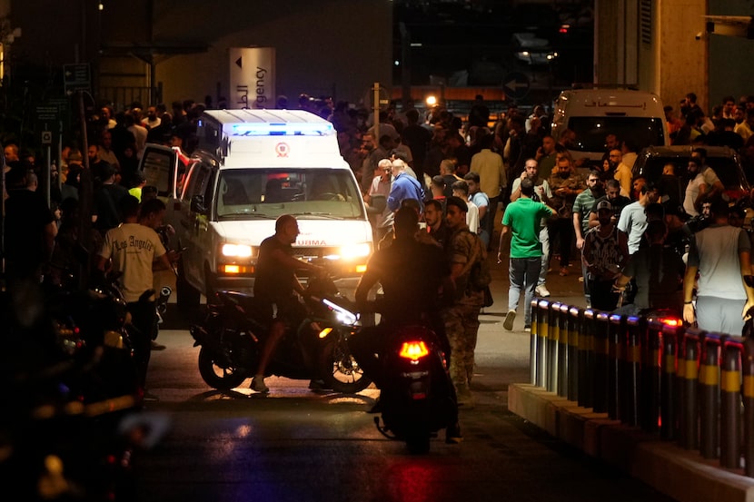 People gather around an ambulance carrying wounded people whose handheld pager exploded, at...