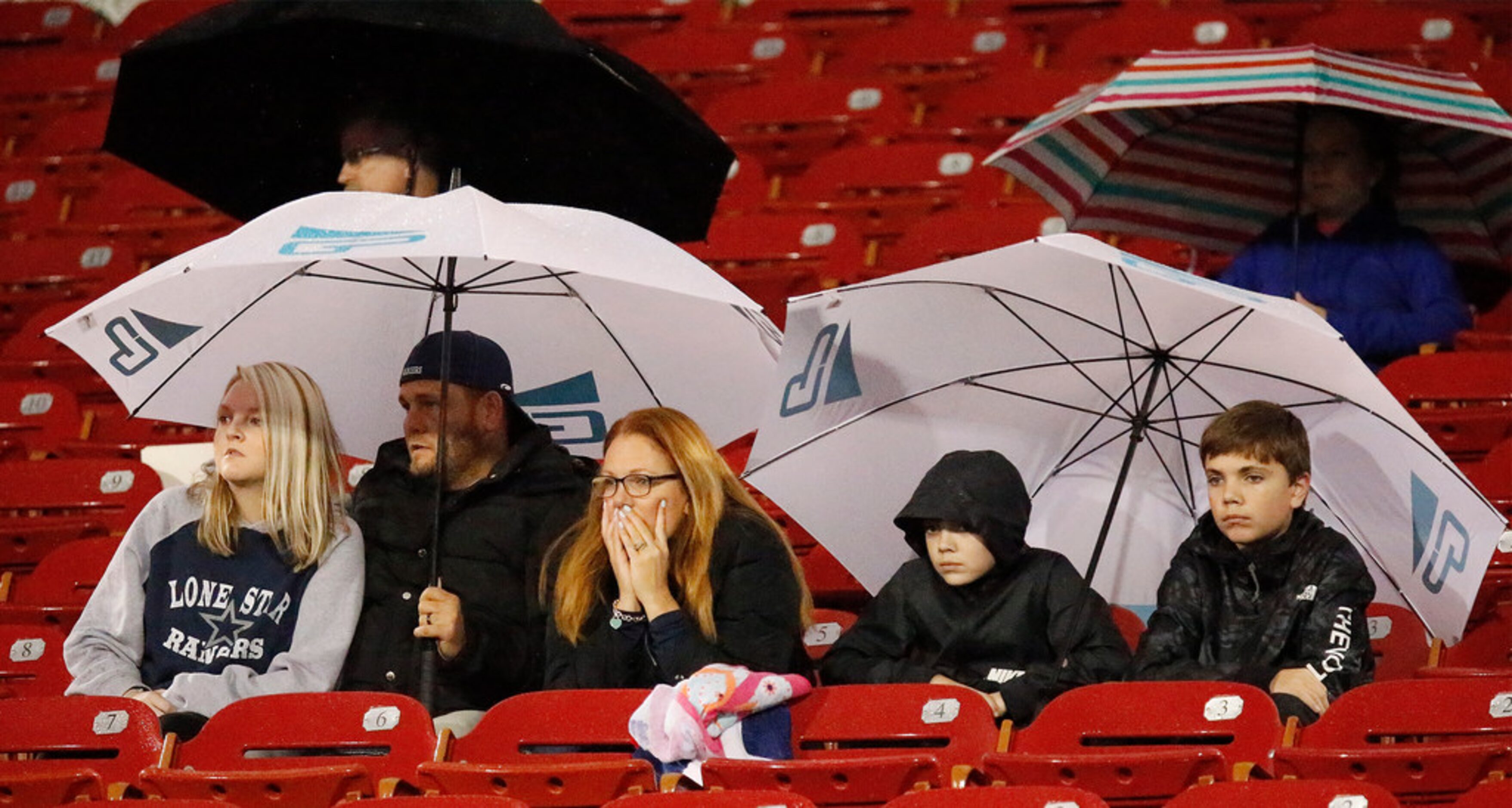 Lone Star High School fans endure a wet Friday night to support their team as Lone Star High...