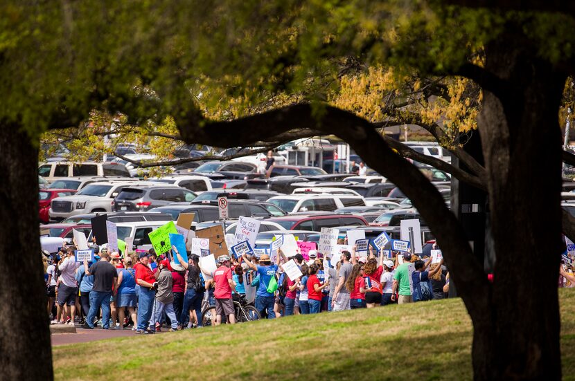 Demonstrators march down Young Street near City Hall.