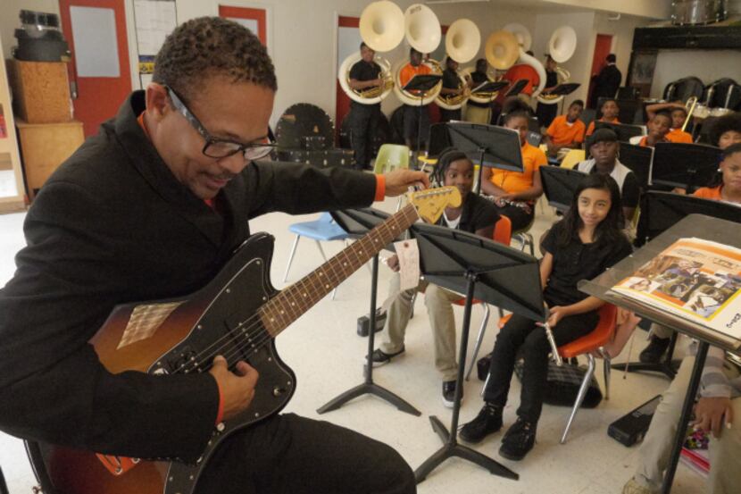 One of Oliver Wendell Holmes Middle School's band directors, Dr. James Browden II, tries out...