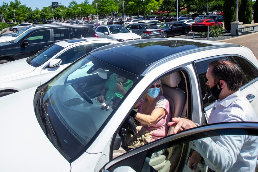 Krystina Broder (center) and her husband, Len, examined a 2019 Mercedes-Benz GLC 300 4MATIC...