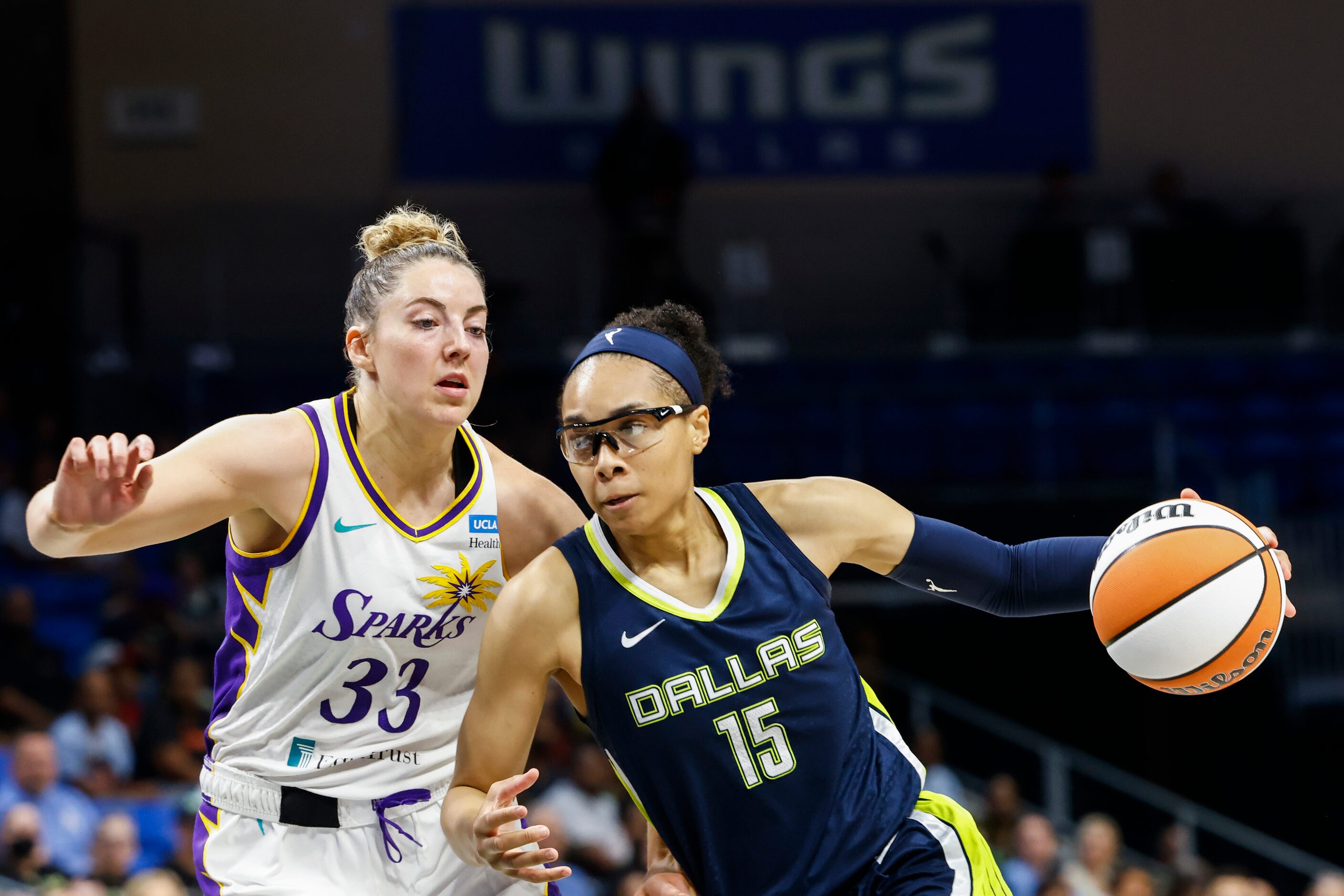 Dallas Wings guard Allisha Gray (15) dribbles past Los Angeles Sparks forward Katie Lou...