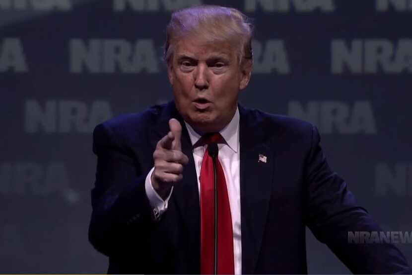 Donald Trump cocked his finger as he pretended to draw a gun on an attacker during an...