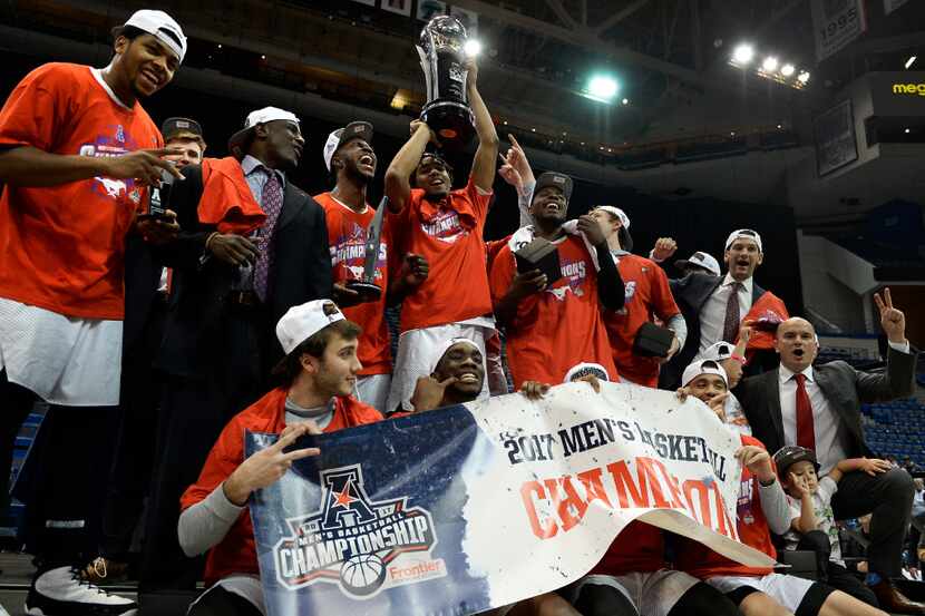 SMU holds up the American Athletic Conference championship trophy after SMU's win against...